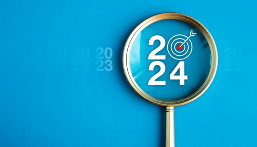 Big white 2024 year number with target icon inside gold magnifying glass on light blue background. 