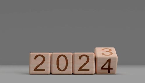 Wooden blocks showing a change in date from 2023 to 2024