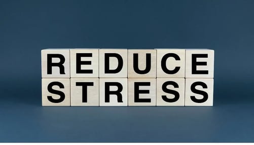 Wooden blocks arranged on a blue background, symbolizing a concept for reducing stress and promoting relaxation.