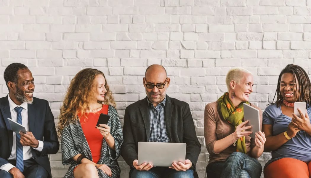 Happy employees receiving internal communications on different devices