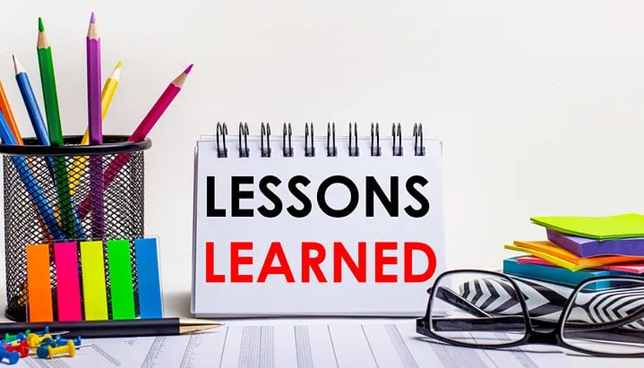 Worktable with scattered stationery and lessons learned written. (1)