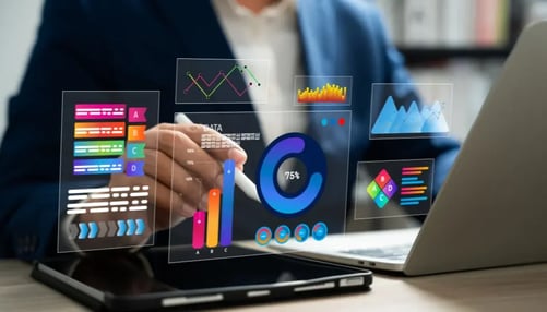 Businessman analyzing data on a laptop, displaying various graphs and charts for financial insights.