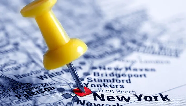 Yellow pin drop at the New York location on a map. (1)